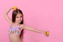 Cute Little Girl In Swimsuit Dancing With Fruit