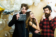© Volodymyr - Lovers celebrate christmas or new year, love triangle. Boyfriends with movie clapper and teddy bear toy. Sensual woman and men in movie or film studio. Cinema theme party for holiday celebration
