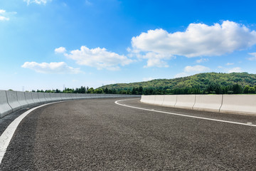 Empty asphalt road and mountains with clouds landscape