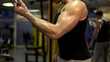 © motortion - Bodybuilder working out in sport club, doing weight pull-down exercise, activity