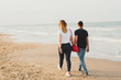 © Road Red Runner - Couple strolling calmly on the warm beach