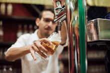Waiter Pulling A Beer In A Pub