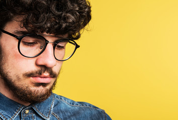 Wall Mural - Portrait of a young man in a studio. Copy space.