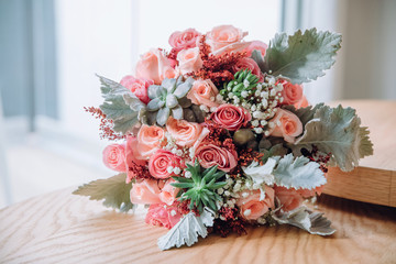 Wall Mural - Rich wedding bouquet made of greenery and pink roses lies on the table