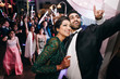 Indian wedding couple takes selfie on the phone standing with their guests in the restaurant