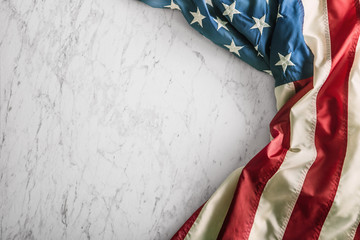 Wall Mural - Close-up american flag on white marble background