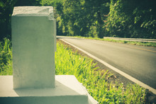 The Kilometres Marker Is Made Of Cement On The Road Side. The Concept Of Tourism Travel.