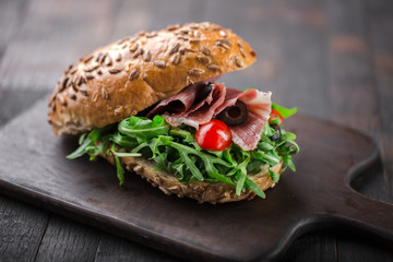 Wall Mural - Tasty Italian sandwich with rucola and Parma ham.