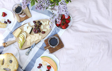 Wall Mural - Summer picnic with cheese, wine, fruits and bread.