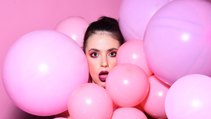 Balloon party on pink studio background. Retro girl with stylish makeup and hair. Birthday decor and celebration. girl dreaming in punchy pastels trend. Fashion woman with many pink air balloons