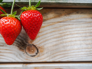 Ripe red strawberries on a wooden background