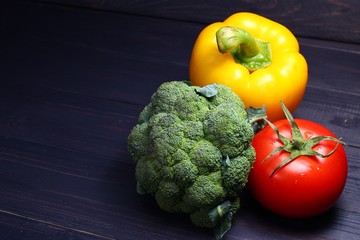 Sticker - Broccoli, sweet peppers and tomatoes on a dark background copy space