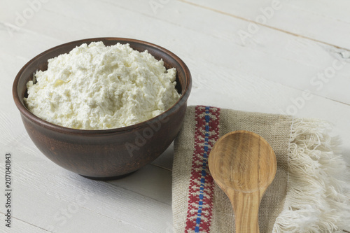 Cottage Cheese In A Brown Ceramic Bowl With Frozen Raspberries And
