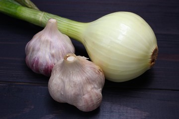 Wall Mural - Onion and garlic on a dark background