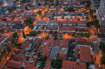 View of the streets lights and house roofs in the early morning lights, at the city of São Paulo. The gigantic city, famous for its cultural and business vocation. Southeast Brazil.