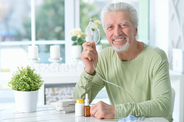 Wall Mural - portrait of an elder man making inhalation