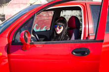 Beautiful Brunette On A Red Car At An Old Airfield