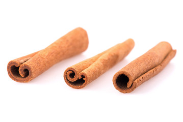 Top view of cinnamon sticks isolated on white