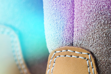 Macro yellow suede boots shoes and shoelaces on wooden backgroun Light toning