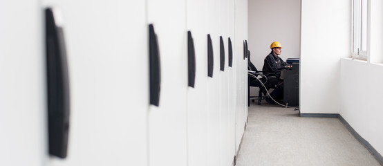 Wall Mural - maintenance engineer inspect relay protection system with laptop computer