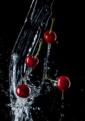 Wall Mural - cherries in the spray of water, fresh fruits falling in water