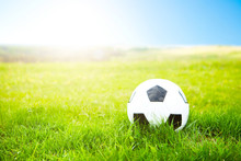 Soccer Ball Or Football Ball On Ground And Green Field Of Grass