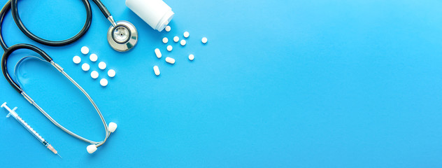 Pills and medical equiupments on light blue banner background