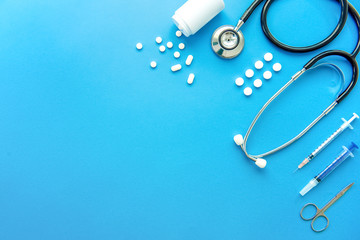 Wall Mural - Pills and medical equiupments on light blue background