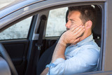 Fototapeta  - Man having toothache while driving car