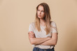 © Drobot Dean - Portrait of an upset casual girl with arms folded
