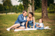 © Aleksandr - happy young family spending time outdoor on a summer day