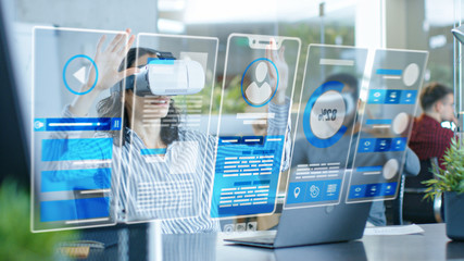 Wall Mural - female virtual reality engineer/ developer wearing virtual reality headset creates content with her 