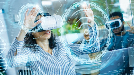 Wall Mural - female virtual reality engineer/ developer wearing virtual reality headset creates content with her 