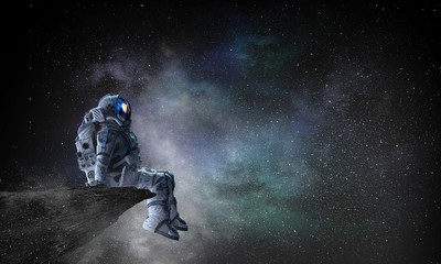 Wall Mural - spaceman on rock edge. mixed media