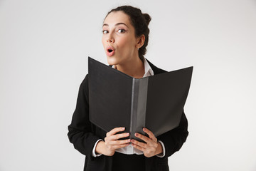 Wall Mural - Excited young business woman holding folder