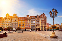 Central Market Square In Wroclaw Poland With Old Colourful Houses, Street Lantern Lamp And Walking Tourists People At Gorgeous Stunning Morning Sunrise Sunshine. Travel Vacation Concept