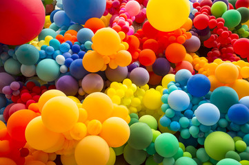 Bright abstract background of jumble of rainbow colored balloons celebrating gay pride