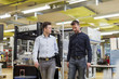 © Westend61 - Two men talking in factory