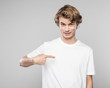 © Snapic.PhotoProduct - Young man in white t-shirt pointing at his chest