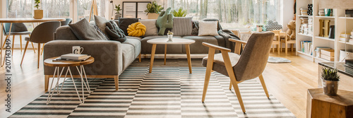 Fotografiet Horizontal photo of a scandi living room interior with a corner sofa, pillows, a