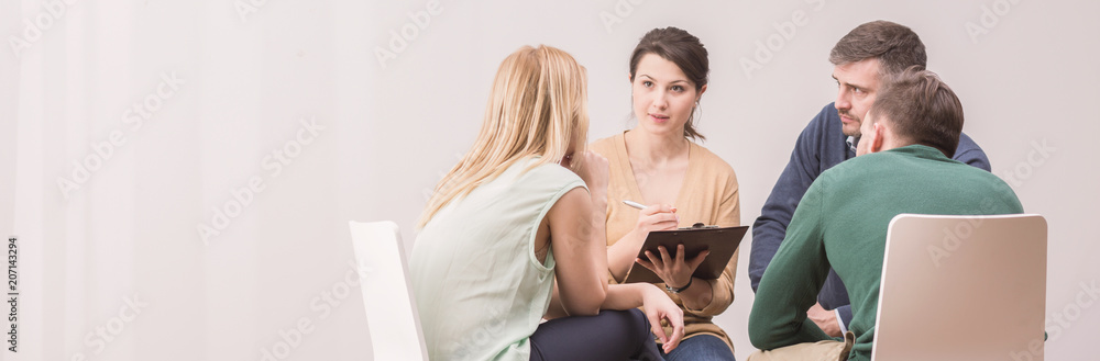 Panorama of female psychologist during meeting with a support group for workaholics - obrazy, fototapety, plakaty 