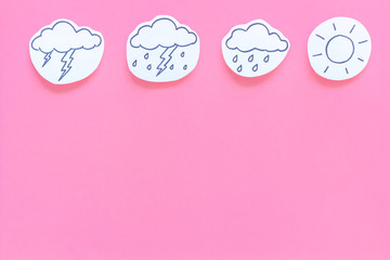 Wall Mural - weather forecast concept. modern weather icons set on pink background top view copy space