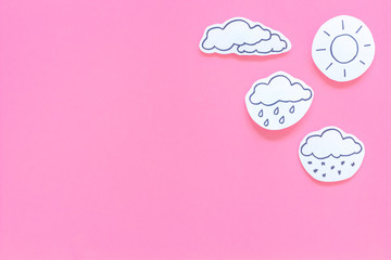 Wall Mural - weather forecast concept. modern weather icons set on pink background top view copy space