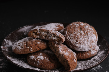 Wall Mural - oatmeal cookies on a black table in castor sugar