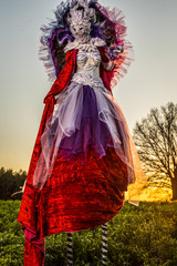 Wall Mural - Fairy tale woman on stilts in bright fantasy stylization. Fine art outdoor photo.