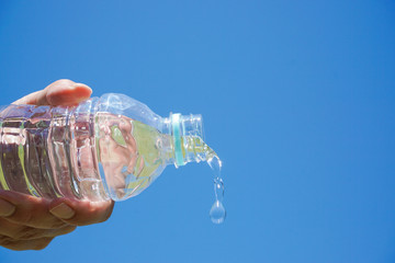  Water flows from the plastic bottle. Image of hydration.  ペットボトルから水が流れる　水分補給のイメージ