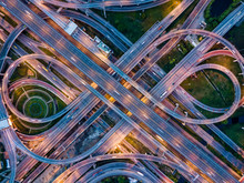 Top View Of Highway Road Junctions At Night. The Intersecting Freeway Road Overpass The Eastern Outer Ring Road Of Bangkok, Thailand.