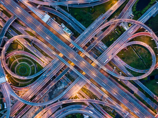 top view of highway road junctions at night. the intersecting freeway road overpass the eastern oute