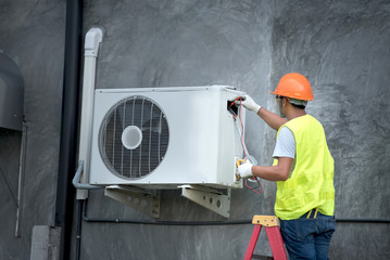 Technician is checking outdoor air conditioner unit