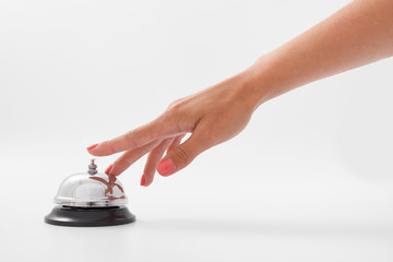 A desk call for the hotel reception. female hand